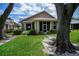 Charming home with a well-maintained front yard, complemented by mature trees and established landscaping at 519 Catalina Isles Cir, Venice, FL 34292