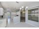 Bright kitchen featuring white cabinets, modern appliances, and an open layout with breakfast bar at 519 Catalina Isles Cir, Venice, FL 34292