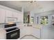Bright kitchen featuring white cabinets, modern appliances, and an adjacent dining space at 519 Catalina Isles Cir, Venice, FL 34292