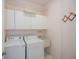 Well-equipped laundry room with a washer, dryer, utility sink, and ample cabinet space for storage at 519 Catalina Isles Cir, Venice, FL 34292