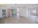 Open living room with sliding glass doors to the lanai and neutral paint throughout at 519 Catalina Isles Cir, Venice, FL 34292