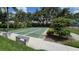 Community shuffleboard courts with greenery, benches, and a glimpse of the tennis court at 519 Catalina Isles Cir, Venice, FL 34292