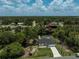 Aerial view of the neighborhood and home, featuring a screened-in pool and private dock at 5306 Maccaughey Dr, North Port, FL 34287