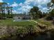 Backyard featuring a screened in pool and wooden dock by the water offering a serene outdoor experience at 5306 Maccaughey Dr, North Port, FL 34287