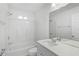 Clean bathroom featuring a shower-tub combo, vanity with a mirror, and bright lighting at 5306 Maccaughey Dr, North Port, FL 34287