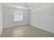 Inviting bedroom with tiled floors, ceiling fan, and a large window for ample natural light at 5306 Maccaughey Dr, North Port, FL 34287