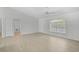 A bright bedroom with tile floors, white walls, a window, and a ceiling fan at 5306 Maccaughey Dr, North Port, FL 34287
