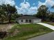 Charming single story home with a well-manicured lawn, a paved driveway, and an attached two-car garage at 5306 Maccaughey Dr, North Port, FL 34287