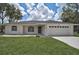 A charming one-story home with a well-maintained lawn, a two-car garage, and a concrete driveway at 5306 Maccaughey Dr, North Port, FL 34287