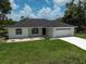 A charming one-story home with a well-maintained lawn, a two-car garage, and a concrete driveway at 5306 Maccaughey Dr, North Port, FL 34287