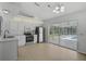 Bright kitchen boasts stainless appliances, white cabinetry, and sliding doors to a screened pool area at 5306 Maccaughey Dr, North Port, FL 34287