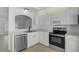 Modern kitchen featuring stainless steel appliances, white cabinetry, and quartz countertops at 5306 Maccaughey Dr, North Port, FL 34287