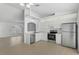Modern kitchen with stainless steel appliances, white cabinets, and a view into the living room at 5306 Maccaughey Dr, North Port, FL 34287