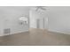 Open living room with tile floors, white walls, with views to other rooms in the house at 5306 Maccaughey Dr, North Port, FL 34287