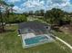 Aerial view of the screened-in pool and patio outside this lovely home at 5306 Maccaughey Dr, North Port, FL 34287