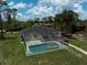 Aerial view of the screened-in pool and patio outside of this lovely home at 5306 Maccaughey Dr, North Port, FL 34287