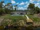 Beautiful backyard with screened-in pool and personal wooden dock over a waterway at 5306 Maccaughey Dr, North Port, FL 34287