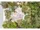 Aerial view of a single-Gathering home with a swimming pool and surrounded by lush greenery and mature trees at 5369 Shadow Lawn Dr, Sarasota, FL 34242