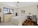 Cozy bedroom with a large window, ceiling fan, and ample natural light at 5369 Shadow Lawn Dr, Sarasota, FL 34242