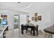 Bright dining area with art-adorned walls and easy access to outdoor pool creating a seamless indoor-outdoor flow at 5369 Shadow Lawn Dr, Sarasota, FL 34242