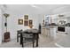 Cozy dining area adjacent to the kitchen with a black dining table and artful decor creating an inviting space at 5369 Shadow Lawn Dr, Sarasota, FL 34242