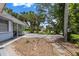 Wide driveway framed by mature trees and tropical landscaping leading to the charming single-story home at 5369 Shadow Lawn Dr, Sarasota, FL 34242