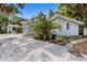 Charming single-story home featuring a well-maintained white rock yard and lush tropical landscaping at 5369 Shadow Lawn Dr, Sarasota, FL 34242