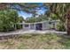 Charming single-story home with a well-manicured front yard and a convenient covered carport at 5369 Shadow Lawn Dr, Sarasota, FL 34242