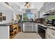 Vintage kitchen featuring gray cabinets, quirky decor, and a cozy, functional layout at 5369 Shadow Lawn Dr, Sarasota, FL 34242