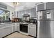 The kitchen boasts gray cabinets, a functional layout, and stainless steel appliances at 5369 Shadow Lawn Dr, Sarasota, FL 34242