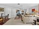 Bright living room with neutral tones, eclectic furnishings, and an open layout perfect for entertaining guests at 5369 Shadow Lawn Dr, Sarasota, FL 34242