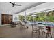 Relaxing screened patio with stylish furniture overlooking the beautiful pool and lush landscaping at 5369 Shadow Lawn Dr, Sarasota, FL 34242