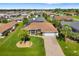 Charming home boasts an attached two-car garage, screened in porch and lush green lawn at 5818 Harrison Rd, Venice, FL 34293