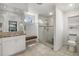 Bathroom featuring a double sink vanity with granite, a glass shower, a bench, and tile flooring at 5818 Harrison Rd, Venice, FL 34293