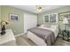 Comfortable bedroom featuring light green walls, wood floors, and white trim at 5818 Harrison Rd, Venice, FL 34293