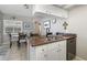 Cozy breakfast nook adjacent to the kitchen, featuring a glass-top table with comfortable seating and natural light at 5818 Harrison Rd, Venice, FL 34293