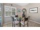 Inviting breakfast area with an elegant table and comfortable chairs, bathed in natural light from the nearby window at 5818 Harrison Rd, Venice, FL 34293