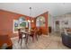 Dining room featuring a wooden table and chairs, chandelier, and a large bright window with shutters at 5818 Harrison Rd, Venice, FL 34293