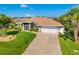 Beautiful single-story home with a well-manicured lawn and a brick-paved driveway at 5818 Harrison Rd, Venice, FL 34293