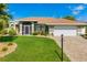Well-maintained home with a two-car garage, screened entry, and professionally landscaped yard at 5818 Harrison Rd, Venice, FL 34293