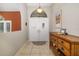 Bright foyer with tile flooring, double doors, and a decorative cabinet adds charm to the home at 5818 Harrison Rd, Venice, FL 34293
