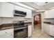 Open kitchen showcasing modern appliances, stylish cabinetry, and a clear view into the dining area at 5818 Harrison Rd, Venice, FL 34293