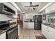 Well-equipped kitchen featuring modern appliances and ample storage space, conveniently located next to an arched doorway at 5818 Harrison Rd, Venice, FL 34293