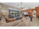 Comfortable living room with a cozy seating area, a television, and sliding glass doors to the backyard pool at 5818 Harrison Rd, Venice, FL 34293