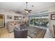 Spacious living room featuring a large sliding glass door with views of the inviting backyard pool area at 5818 Harrison Rd, Venice, FL 34293