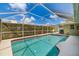 A screened-in swimming pool offers privacy and sun protection, nestled within well-maintained landscaping at 5818 Harrison Rd, Venice, FL 34293
