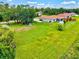 Aerial view showcasing a large backyard, fenced perimeter, and screened lanai at 5954 Gottfried Ln, North Port, FL 34291