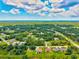 Aerial shot showcasing a residential neighborhood with a mix of homes and abundant greenery at 5954 Gottfried Ln, North Port, FL 34291