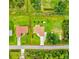 Aerial view of a property with spacious green lawns, an adjacent house, and a clearly outlined property line at 5954 Gottfried Ln, North Port, FL 34291