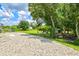 Lush backyard area featuring gravel area and ample natural shading at 5954 Gottfried Ln, North Port, FL 34291